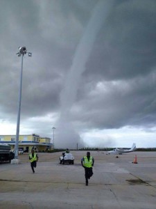 Airport workers run as tornado approaches (Photo: WSVN facebook page)